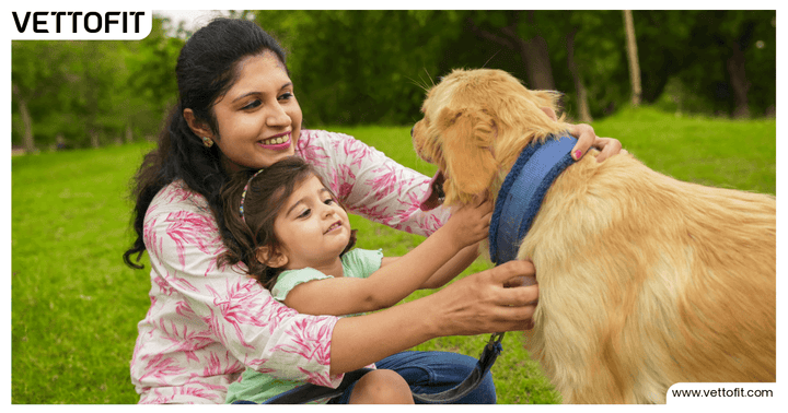 Mother and daughter bonding with their golden retriever in a park — capturing the emotional side of pet parenting, supported by Vettofit.